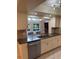 Kitchen boasts granite countertops, stainless steel appliances, and a seamless view into the dining area at 7011 Archwood Dr, Orlando, FL 32819