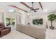 Bright living room features vaulted ceiling, wooden beams, and sliding glass doors to a covered patio at 7011 Archwood Dr, Orlando, FL 32819