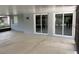 Covered patio area with block walls, dual sliding glass doors and neutral coloring at 7011 Archwood Dr, Orlando, FL 32819