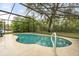 Screened-in kidney shaped pool is surrounded by lush landscaping for extra privacy at 7011 Archwood Dr, Orlando, FL 32819