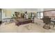 Recreation room with bar seating, mini fridge, and pool table covered for protection at 7011 Archwood Dr, Orlando, FL 32819
