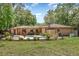 View of the backyard, showcasing the in-ground swimming pool, patio, and mature landscaping at 7205 June Bug Ln, Orlando, FL 32818