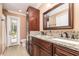 Elegant bathroom with a double vanity, granite countertop, and a door to the outside at 7205 June Bug Ln, Orlando, FL 32818