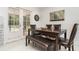 Bright dining area featuring stylish furniture, ample natural light, and a view of the lush outdoors at 7205 June Bug Ln, Orlando, FL 32818