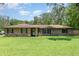 Charming single-story brick home with a well-manicured lawn and lush landscaping at 7205 June Bug Ln, Orlando, FL 32818