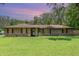 Charming brick home with a well-manicured lawn, mature trees, and a cozy, inviting appeal at 7205 June Bug Ln, Orlando, FL 32818