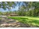 Property featuring expansive green space and trees offering privacy and beauty, complemented by long driveway at 7205 June Bug Ln, Orlando, FL 32818