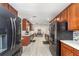 Spacious eat-in kitchen featuring marble countertops, black appliances, and a well-lit dining area at 7205 June Bug Ln, Orlando, FL 32818