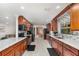 Modern kitchen with sleek marble countertops, wood cabinets, black appliances, and stylish backsplash at 7205 June Bug Ln, Orlando, FL 32818