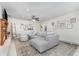 Bright living room featuring a large sectional sofa, neutral decor, and a cozy fireplace at 7205 June Bug Ln, Orlando, FL 32818