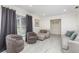 Relaxing living room featuring neutral tones, tile flooring, comfortable seating and natural light at 7205 June Bug Ln, Orlando, FL 32818
