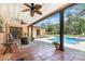 Covered patio with ceiling fans, outdoor seating, and a view of the in-ground swimming pool at 7205 June Bug Ln, Orlando, FL 32818