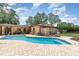 Backyard view of an in-ground swimming pool with brick paver patio and mature landscaping at 7205 June Bug Ln, Orlando, FL 32818