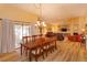 Open-concept dining area with wood floors that flows into a spacious living room at 8143 Terragona Ct, Orlando, FL 32836