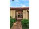 Inviting gated entrance leading to a cozy home with a brick path and lush greenery at 8143 Terragona Ct, Orlando, FL 32836