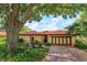 Charming single-story home with a brick driveway, clay tile roof, and mature landscaping at 8143 Terragona Ct, Orlando, FL 32836