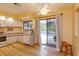 Spacious kitchen with backyard pool view, featuring wooden floors and bright interior paint at 8143 Terragona Ct, Orlando, FL 32836