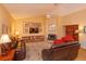 Inviting living room featuring a fireplace, shelving and comfortable leather seating at 8143 Terragona Ct, Orlando, FL 32836