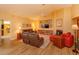 Cozy living room with vaulted ceilings, a fireplace, and comfortable leather furniture at 8143 Terragona Ct, Orlando, FL 32836