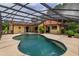 Screened-in pool with an attached spa and patio area at 8143 Terragona Ct, Orlando, FL 32836