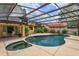 Screened-in pool with an attached spa and patio area at 8143 Terragona Ct, Orlando, FL 32836
