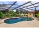 Screened-in pool with an attached spa and lush landscaping at 8143 Terragona Ct, Orlando, FL 32836