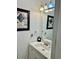 Stylish half bath featuring modern fixtures, framed mirror, and decorative accents at 932 S Lake Sterling Ct, Casselberry, FL 32707