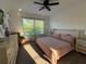 This bright bedroom features a large window, hard surface floors, and neutral decor at 932 S Lake Sterling Ct, Casselberry, FL 32707