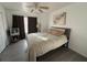 Cozy bedroom featuring laminate floors, a neutral color palette, and a ceiling fan at 932 S Lake Sterling Ct, Casselberry, FL 32707