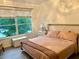 This well-lit bedroom includes a scenic view, a neutral palette, and hard surface floors at 932 S Lake Sterling Ct, Casselberry, FL 32707