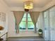 Bright dining area with stylish decor, elegant lighting, and a large window with backyard views at 932 S Lake Sterling Ct, Casselberry, FL 32707