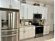 Modern kitchen with stainless steel appliances, granite countertops, and white shaker cabinets at 932 S Lake Sterling Ct, Casselberry, FL 32707