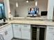 Open concept kitchen with granite countertops, white cabinetry, stainless wine cooler, and pendant lighting at 932 S Lake Sterling Ct, Casselberry, FL 32707