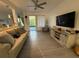 Inviting living room showcasing hardwood floors, neutral walls, comfortable seating, and a sliding glass door at 932 S Lake Sterling Ct, Casselberry, FL 32707