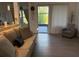 Cozy living room boasting hardwood floors, a comfortable couch, ample natural light, and access to the patio at 932 S Lake Sterling Ct, Casselberry, FL 32707