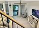 Bright living room showcasing hardwood floors, a flatscreen television, sliding glass doors, and a modern ceiling fan at 932 S Lake Sterling Ct, Casselberry, FL 32707
