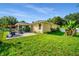 Lush backyard featuring a screened lanai and a patio, offering a perfect blend of indoor and outdoor living at 969 Springs Landing Dr, Deltona, FL 32725