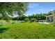 Spacious backyard featuring a patio, white picket fence, mature trees, and well-maintained lawn at 969 Springs Landing Dr, Deltona, FL 32725