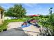 A well-maintained backyard featuring a swing, a patio and green grass at 969 Springs Landing Dr, Deltona, FL 32725