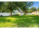Private backyard with a shed and mature trees, ideal for outdoor activities and relaxation at 969 Springs Landing Dr, Deltona, FL 32725