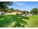 Spacious backyard featuring lush green grass and a home exterior in a serene residential setting at 969 Springs Landing Dr, Deltona, FL 32725