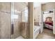 Beautiful bathroom featuring a walk-in shower, soaking tub and a glimpse into the adjacent bedroom at 969 Springs Landing Dr, Deltona, FL 32725