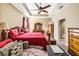 Comfortable bedroom featuring a tray ceiling with fan, a large bed, and traditional wooden furniture at 969 Springs Landing Dr, Deltona, FL 32725