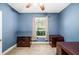 Bedroom with blue walls, ceiling fan, and window letting in natural light at 969 Springs Landing Dr, Deltona, FL 32725