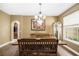 Dining area with wood table and chairs, view to living spaces, and lots of sunlight at 969 Springs Landing Dr, Deltona, FL 32725