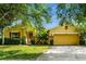 Charming single-story home with a well-manicured front lawn and a two-car garage at 969 Springs Landing Dr, Deltona, FL 32725