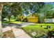 Inviting home exterior featuring a well-kept lawn, mature trees, and a two-car garage at 969 Springs Landing Dr, Deltona, FL 32725
