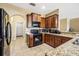 Modern kitchen with granite countertops, wood cabinetry, and tile flooring at 969 Springs Landing Dr, Deltona, FL 32725
