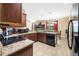 Well-equipped kitchen featuring granite countertops, stainless steel appliances, and wood cabinets at 969 Springs Landing Dr, Deltona, FL 32725