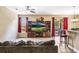 Cozy living room with tile flooring, entertainment center, and access to the patio at 969 Springs Landing Dr, Deltona, FL 32725